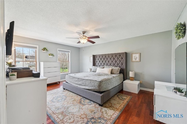 3011 Heather Downs Dr, Findlay, OH 45840 - bedroom with baseboards, a textured ceiling, dark wood-type flooring, ceiling fan, and arched walkways