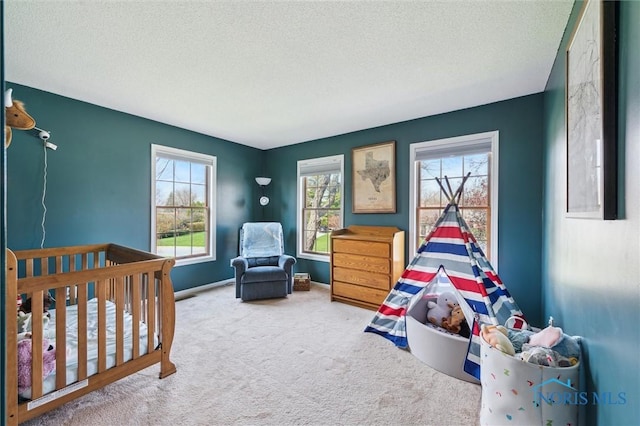 3011 Heather Downs Dr, Findlay, OH 45840 - bedroom featuring a nursery area, baseboards, carpet flooring, and a textured ceiling