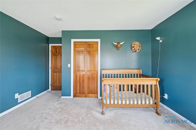 3011 Heather Downs Dr, Findlay, OH 45840 - carpeted bedroom with a crib, visible vents, a closet, and baseboards