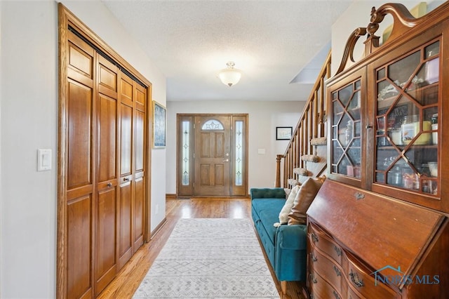 3011 Heather Downs Dr, Findlay, OH 45840 - foyer with light wood-style floors, baseboards, and stairway