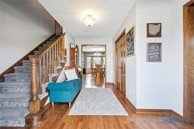 3011 Heather Downs Dr, Findlay, OH 45840 - foyer entrance featuring stairs, baseboards, an inviting chandelier, and wood finished floors