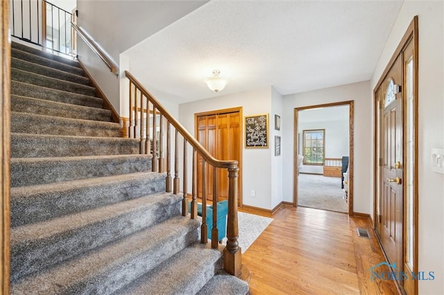 3011 Heather Downs Dr, Findlay, OH 45840 - entryway featuring stairway, light wood finished floors, visible vents, and baseboards