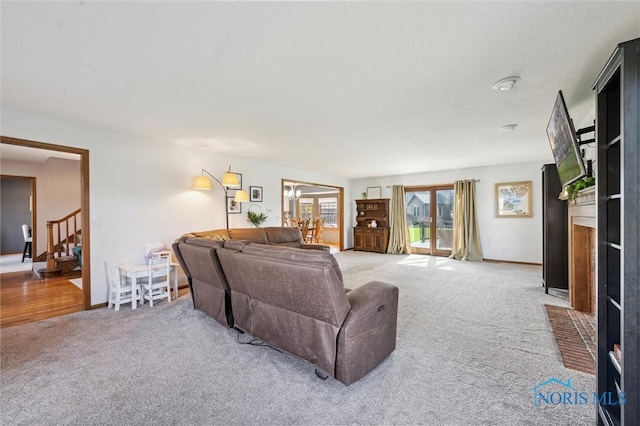3011 Heather Downs Dr, Findlay, OH 45840 - living area with light carpet, stairs, a fireplace with flush hearth, and baseboards