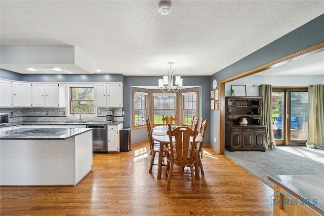 3011 Heather Downs Dr, Findlay, OH 45840 - kitchen with an inviting chandelier, light wood-type flooring, a textured ceiling, white cabinetry, and stainless steel appliances