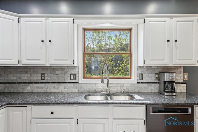 3011 Heather Downs Dr, Findlay, OH 45840 - kitchen with dark stone counters, stainless steel dishwasher, white cabinetry, a sink, and backsplash
