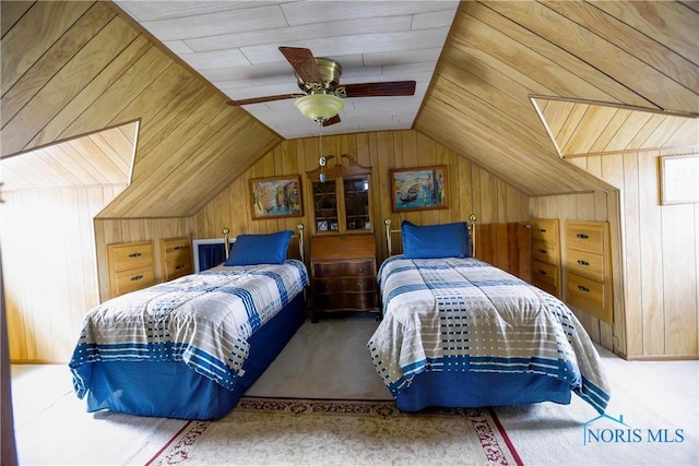 bedroom with lofted ceiling, wooden walls, ceiling fan, and carpet flooring