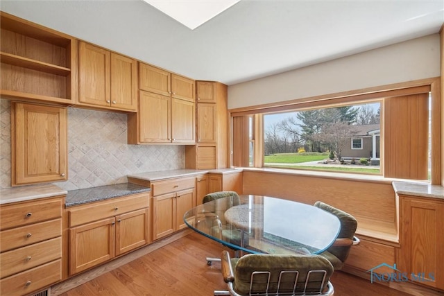 371 Canal Rd, Waterville, OH 43566 - kitchen featuring light wood-style flooring, light countertops, and backsplash