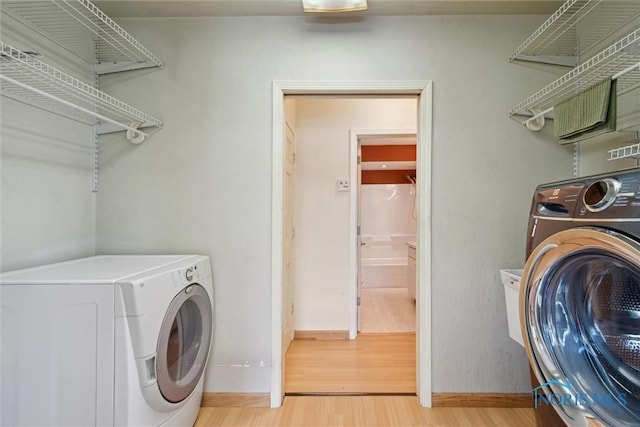 371 Canal Rd, Waterville, OH 43566 - laundry room with light wood-type flooring, separate washer and dryer, laundry area, and baseboards
