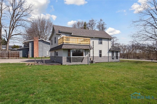 371 Canal Rd, Waterville, OH 43566 - rear view of property featuring stone siding, a balcony, a lawn, and central air condition unit