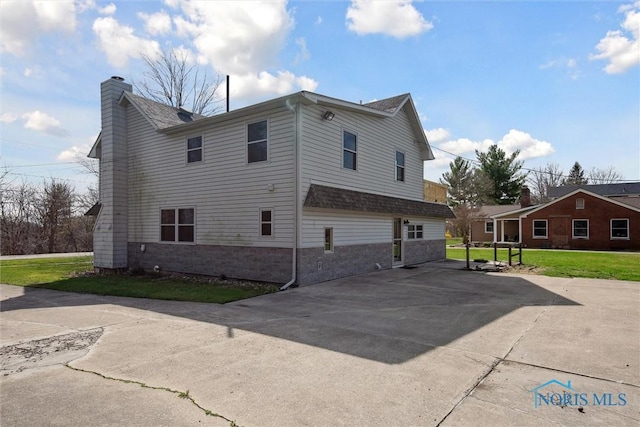 371 Canal Rd, Waterville, OH 43566 - view of property exterior featuring a chimney, a lawn, and concrete driveway