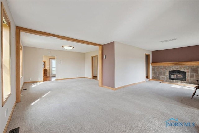 371 Canal Rd, Waterville, OH 43566 - unfurnished living room with light carpet, a glass covered fireplace, and visible vents