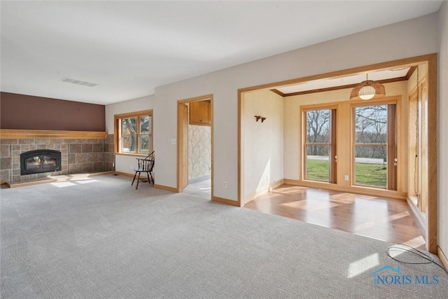 371 Canal Rd, Waterville, OH 43566 - unfurnished living room with a fireplace, visible vents, baseboards, and carpet floors