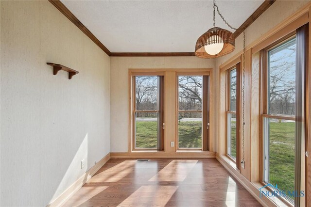 371 Canal Rd, Waterville, OH 43566 - unfurnished sunroom with crown molding, wood finished floors, baseboards, and visible vents