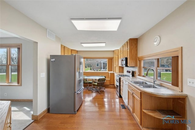 371 Canal Rd, Waterville, OH 43566 - kitchen featuring light wood-style flooring, open shelves, appliances with stainless steel finishes, light countertops, and a sink