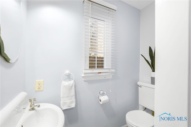 bathroom featuring toilet and a sink