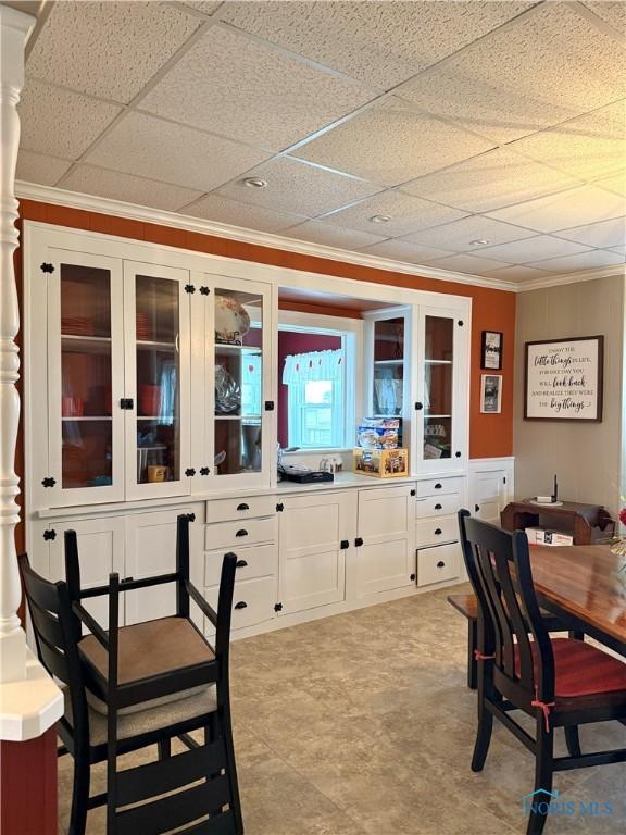 dining space with crown molding