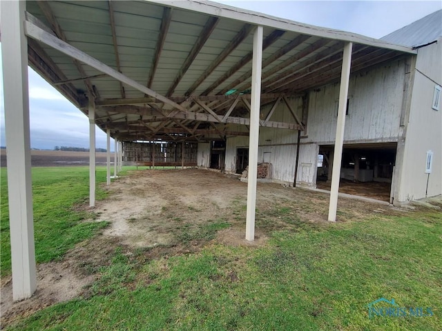exterior space with a garage, an outbuilding, and a carport
