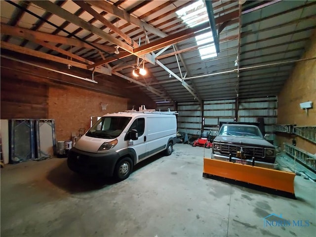 garage featuring metal wall and a garage door opener