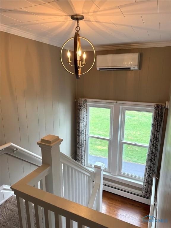 stairway featuring crown molding, a wall mounted AC, a baseboard heating unit, and an inviting chandelier