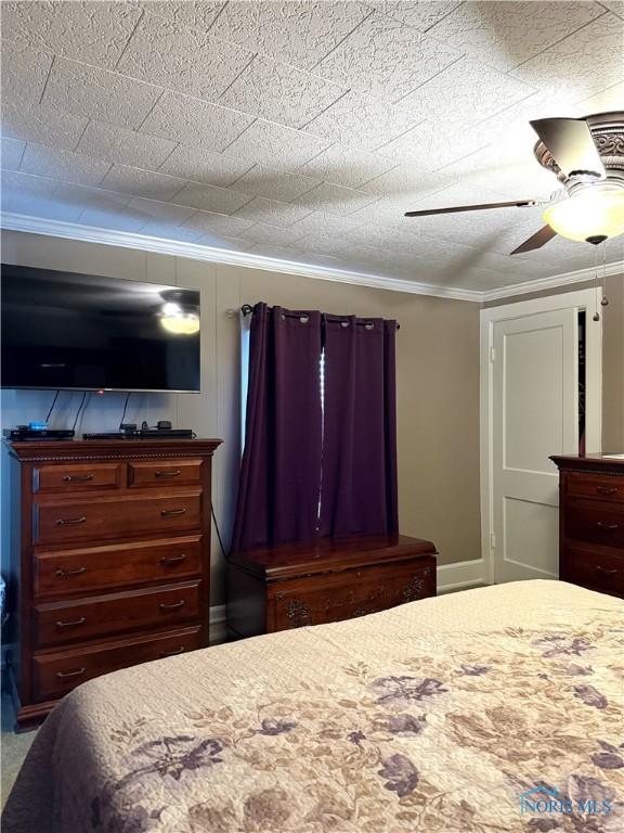 bedroom with crown molding, ceiling fan, and a textured ceiling