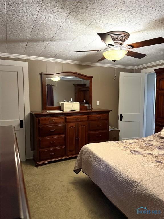 bedroom featuring ornamental molding and a ceiling fan
