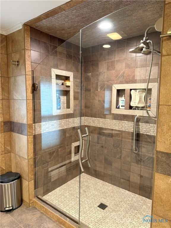 full bathroom with tile patterned floors and a shower stall