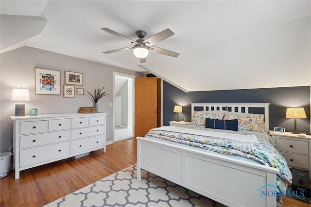 bedroom featuring vaulted ceiling, wood finished floors, and ceiling fan