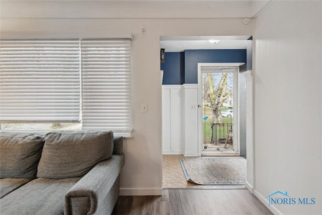 entryway with baseboards and wood finished floors