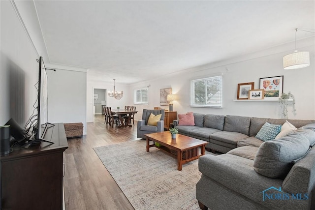 living area with wood finished floors and a chandelier