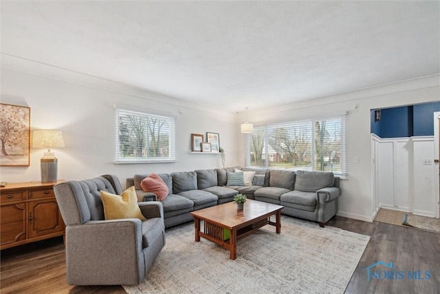 living area featuring baseboards and wood finished floors
