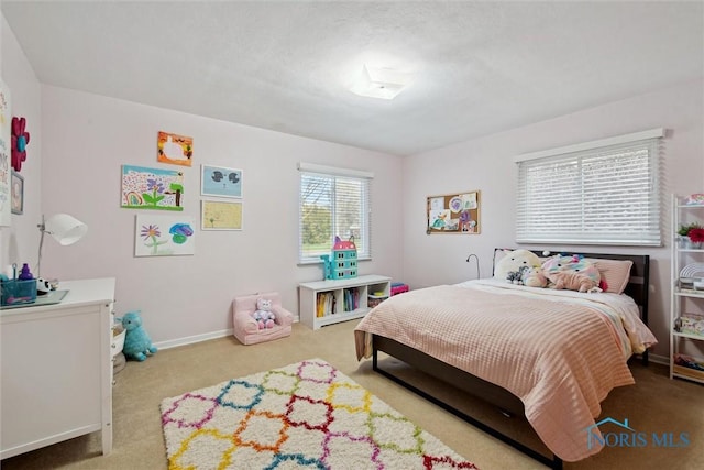 carpeted bedroom featuring baseboards