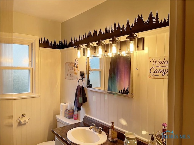 half bathroom featuring toilet and vanity