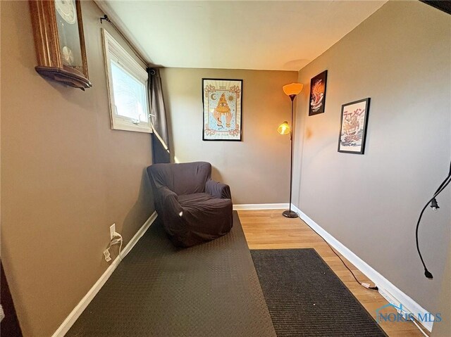 living area with light wood finished floors and baseboards