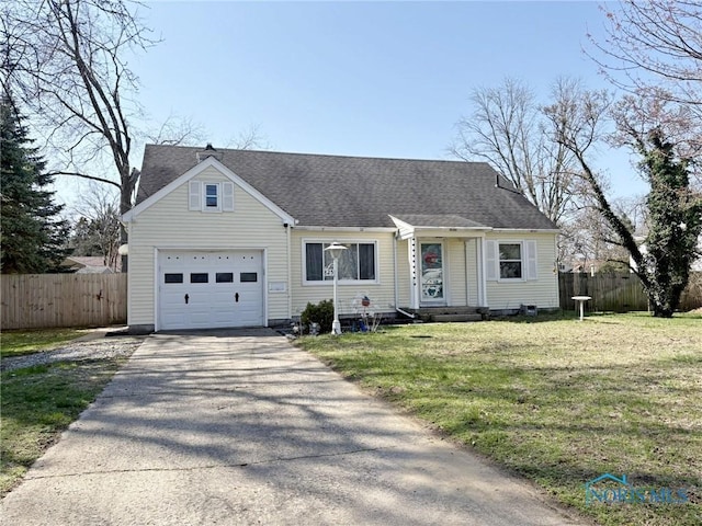 view of front of property with aphalt driveway, a garage, fence, and a front yard