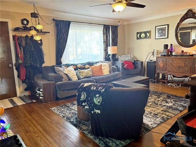 living room with crown molding, wood finished floors, and a ceiling fan