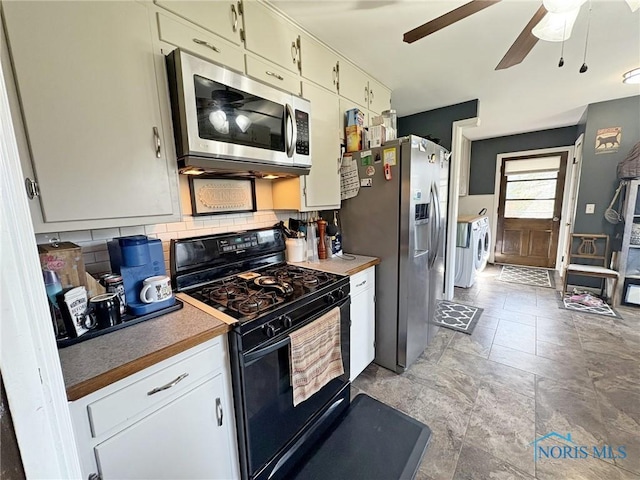 kitchen featuring tasteful backsplash, separate washer and dryer, a ceiling fan, stainless steel appliances, and stone finish flooring