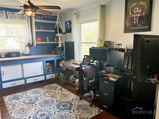 home office with a ceiling fan and dark wood finished floors