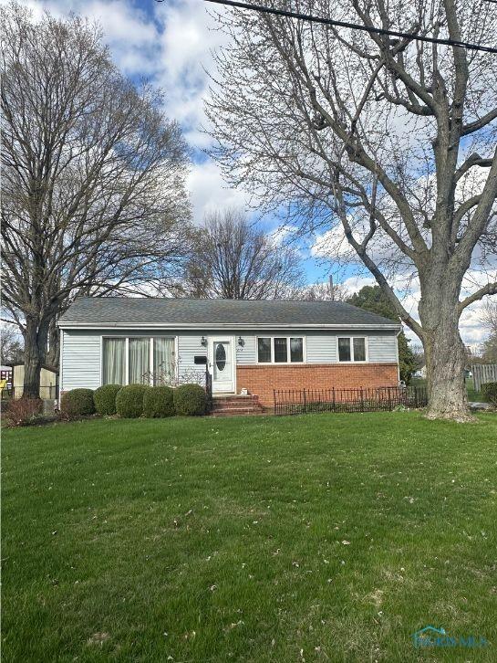 single story home with a front yard and brick siding