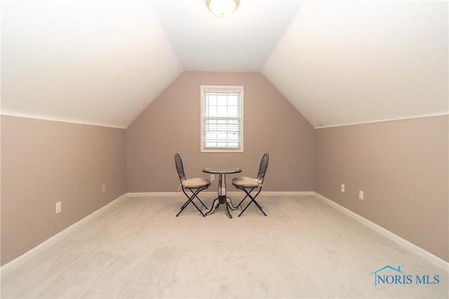 dining space featuring baseboards, lofted ceiling, and carpet flooring