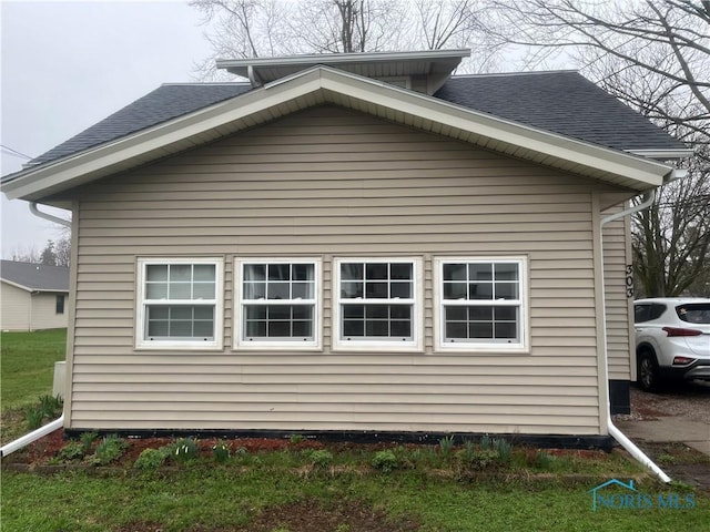 view of property exterior featuring roof with shingles