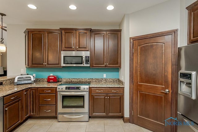 3643 Boulder Ridge Dr, Maumee, OH 43537 - kitchen featuring light stone counters, dark brown cabinets, light tile patterned floors, pendant lighting, and stainless steel appliances