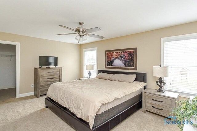 3643 Boulder Ridge Dr, Maumee, OH 43537 - bedroom with a closet, a walk in closet, ceiling fan, light colored carpet, and baseboards