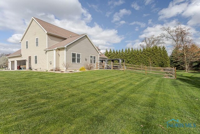 3643 Boulder Ridge Dr, Maumee, OH 43537 - back of property with fence, roof with shingles, and a yard
