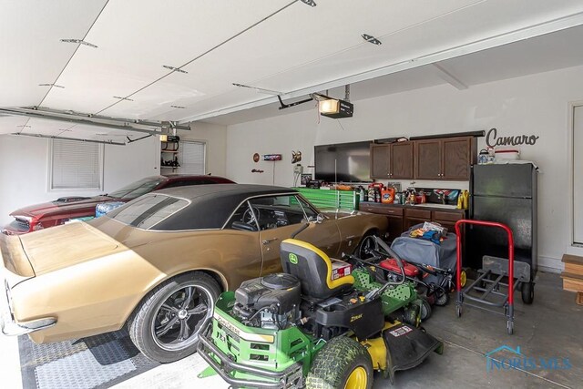 3643 Boulder Ridge Dr, Maumee, OH 43537 - garage featuring freestanding refrigerator and a garage door opener