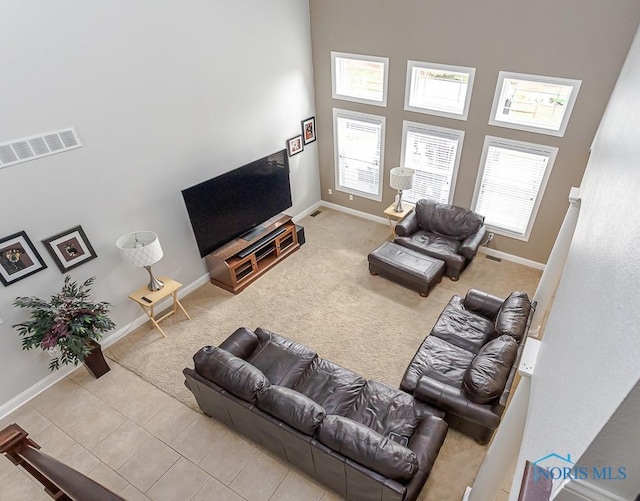 3643 Boulder Ridge Dr, Maumee, OH 43537 - living area featuring baseboards, visible vents, a high ceiling, and carpet flooring