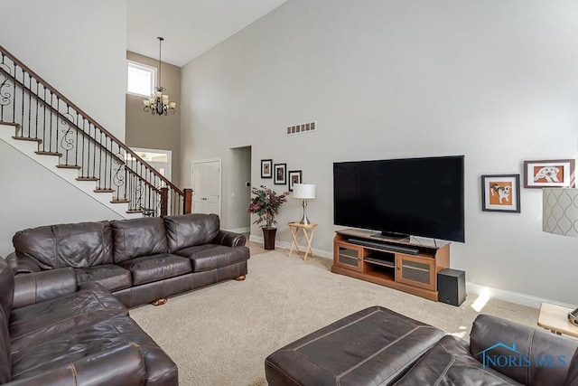 3643 Boulder Ridge Dr, Maumee, OH 43537 - carpeted living room featuring baseboards, visible vents, a notable chandelier, a high ceiling, and stairway