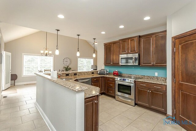 3643 Boulder Ridge Dr, Maumee, OH 43537 - kitchen with stainless steel appliances, light tile patterned floors, light stone countertops, a peninsula, and hanging light fixtures