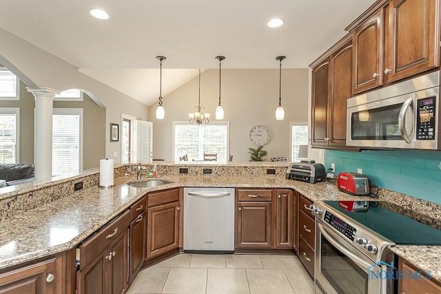 3643 Boulder Ridge Dr, Maumee, OH 43537 - kitchen featuring ornate columns, stainless steel appliances, vaulted ceiling, light tile patterned floors, and a sink