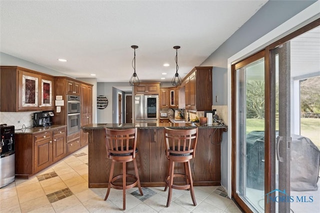 7106 Country Creek Rd, Maumee, OH 43537 - kitchen with appliances with stainless steel finishes, tasteful backsplash, glass insert cabinets, and recessed lighting