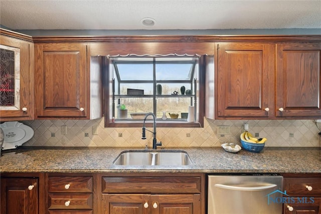 7106 Country Creek Rd, Maumee, OH 43537 - kitchen featuring stainless steel dishwasher, a sink, tasteful backsplash, and dark stone countertops